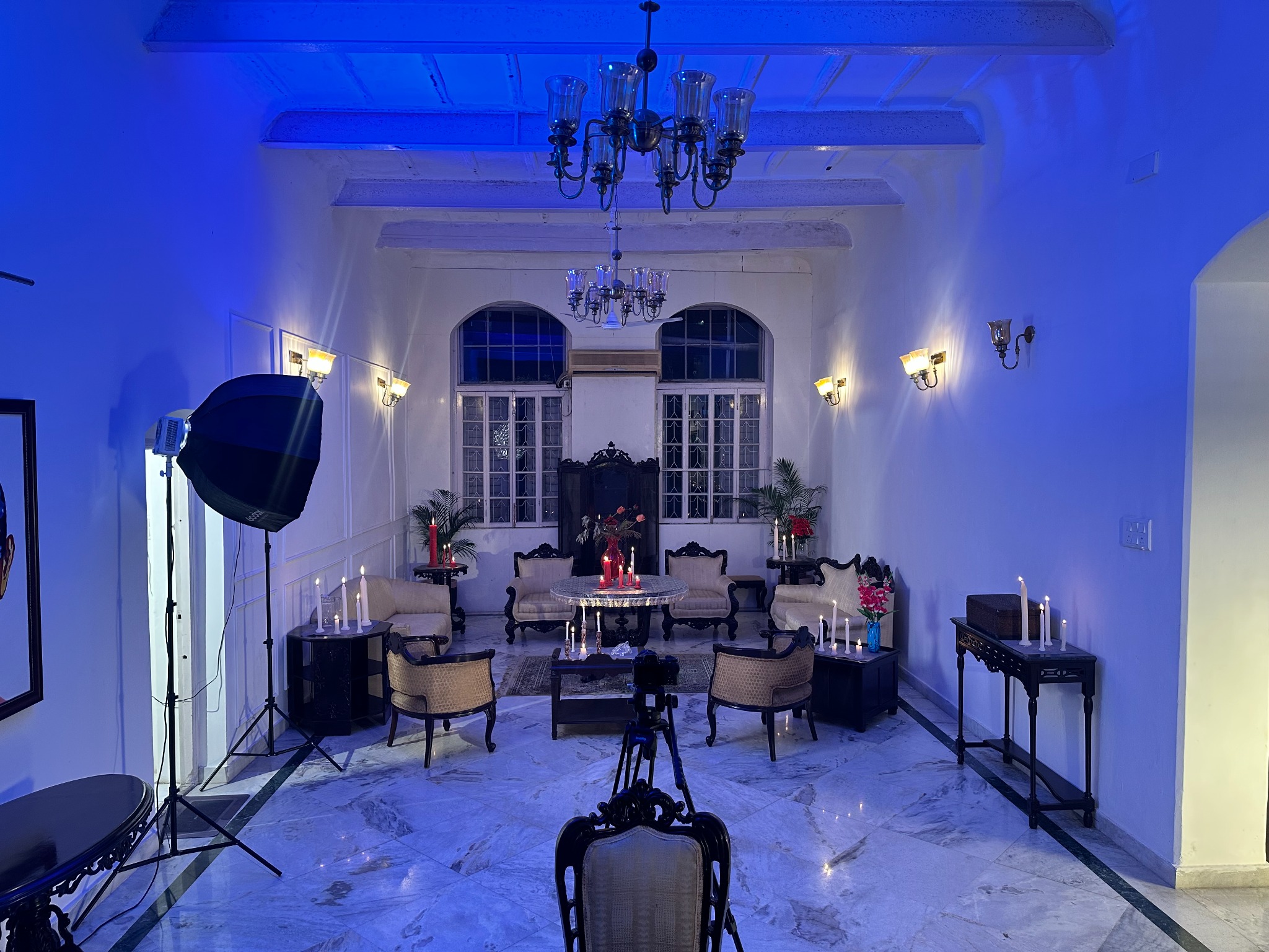 The Hundredth Chamber salon prepared with blue ambience, candles, camera and studio light