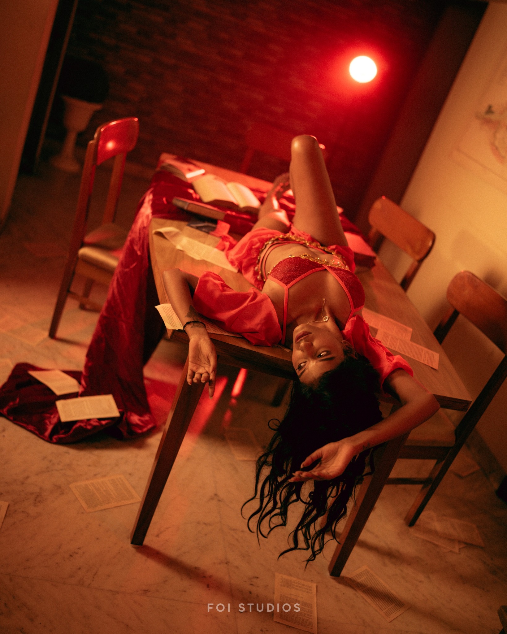 Tithi Ghosh photographed across a table in the red Snowra set