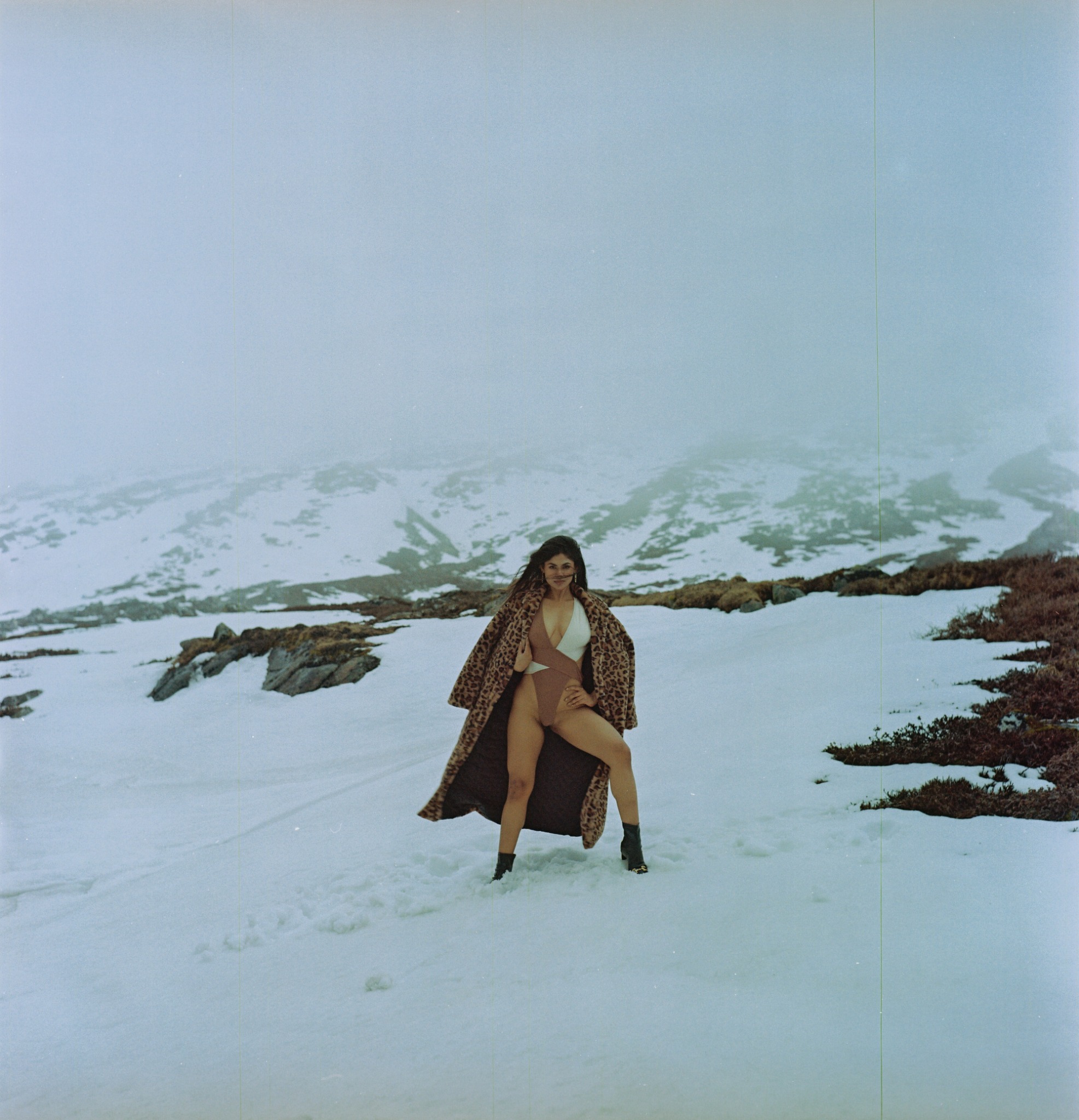 Portrait in snow and leopard-patterned outerwear